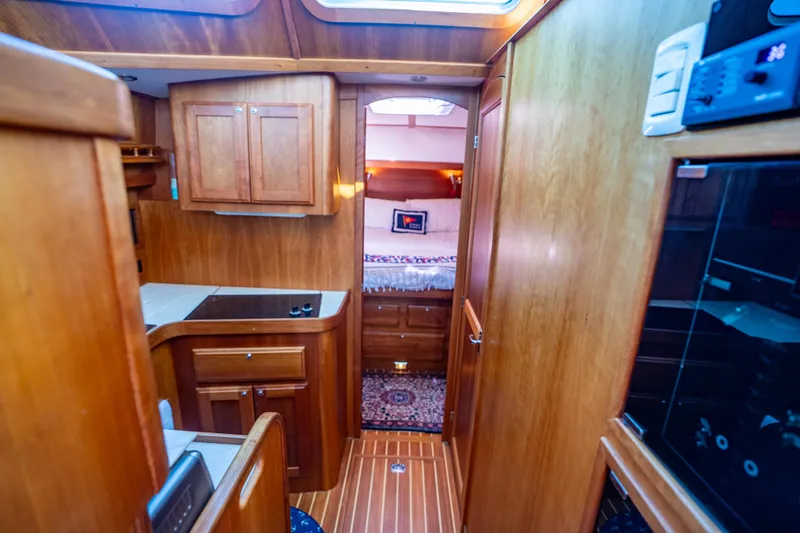 Slide: The Image of Interior of 2006 Sabreline 36 Fly yacht with wooden cabinetry and cozy bedroom. - 89