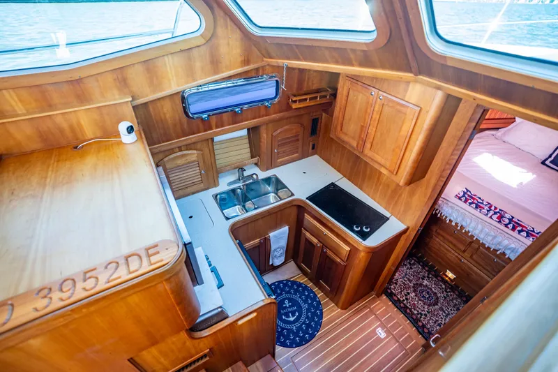 Slide: The Image of Interior of 2006 Sabreline 36 Fly yacht with wooden cabinetry and compact kitchen. - 91