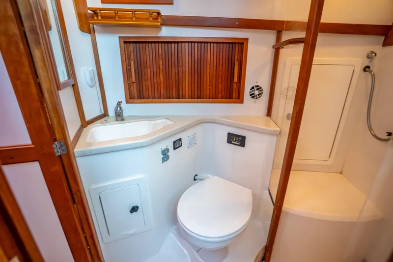 Slide: The Image of Bathroom interior of 2006 Sabreline 36 Fly yacht with wooden accents and modern fixtures. - 98