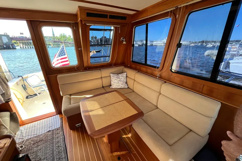 Slide: The Image of Interior of 2006 Sabre 36 Flybridge Sedan with beige seating and waterfront view. - 19