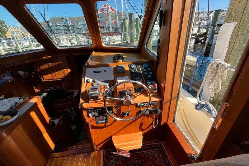 Slide: The Image of Interior view of 2006 Sabre 36 Flybridge Sedan helm with wooden finish and navigation equipment. - 21
