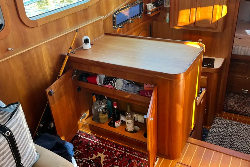 Slide: The Image of Interior of 2006 Sabre 36 Flybridge Sedan with wooden cabinetry and open storage. - 27