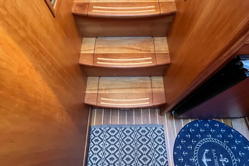 Slide: The Image of Wooden stairs and patterned rug inside 2006 Sabre 36 Flybridge Sedan yacht. - 31