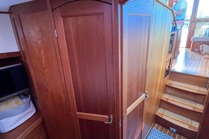 Slide: The Image of Interior of 2006 Sabre 36 Flybridge Sedan with wooden cabinetry and stairs. - 32