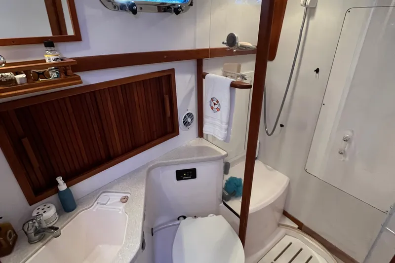 Slide: The Image of Bathroom interior of 2006 Sabre 36 Flybridge Sedan yacht, featuring sink, shower, and wooden accents. - 35
