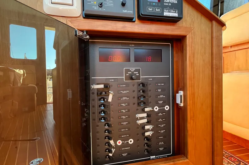 Slide: The Image of Electrical panel inside a 2006 Sabre 36 Flybridge Sedan boat, showcasing controls and switches. - 37