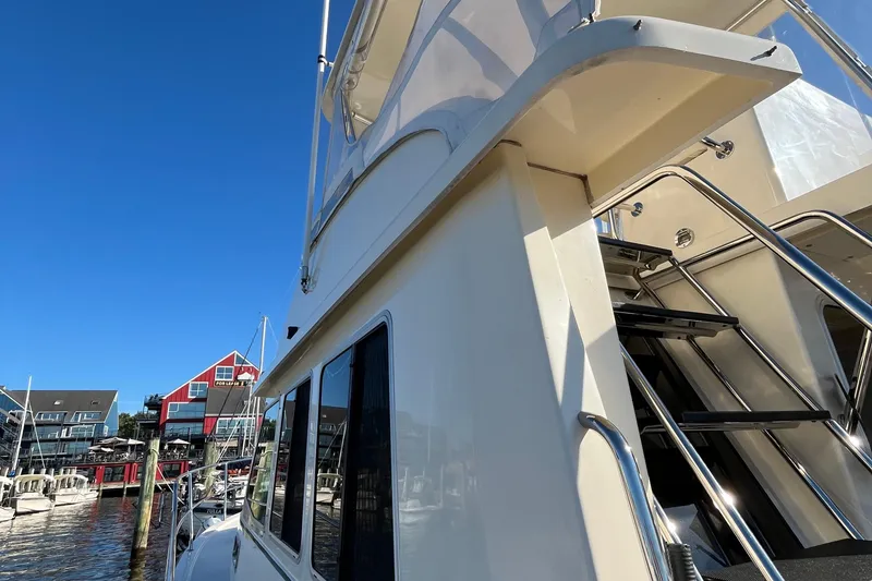 Slide: The Image of 2006 Sabre 36 Flybridge Sedan yacht docked at marina, showcasing sleek design and upper deck stairs. - 8