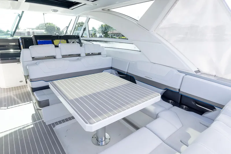 Slide: The Image of 2019 Formula 430 Super Sport Crossover interior with sleek seating and table. - 15