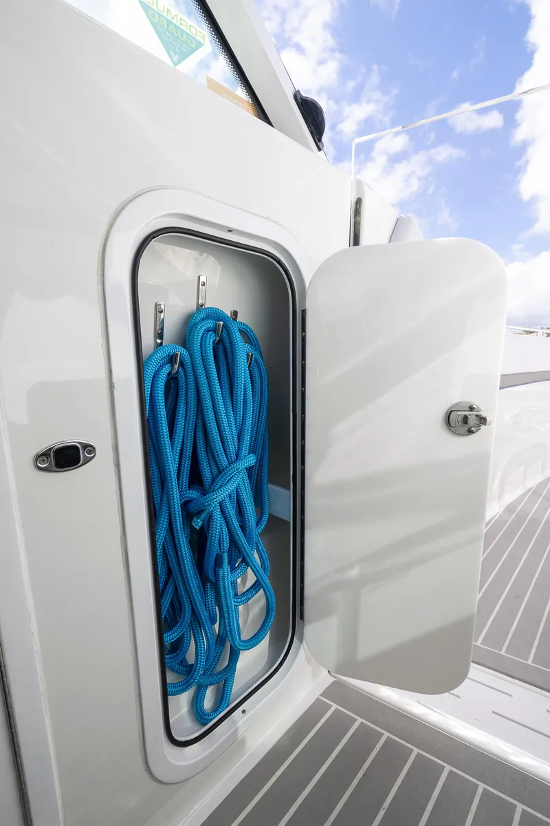 Slide: The Image of Storage compartment with blue ropes on 2019 Formula 430 Super Sport Crossover boat. - 26