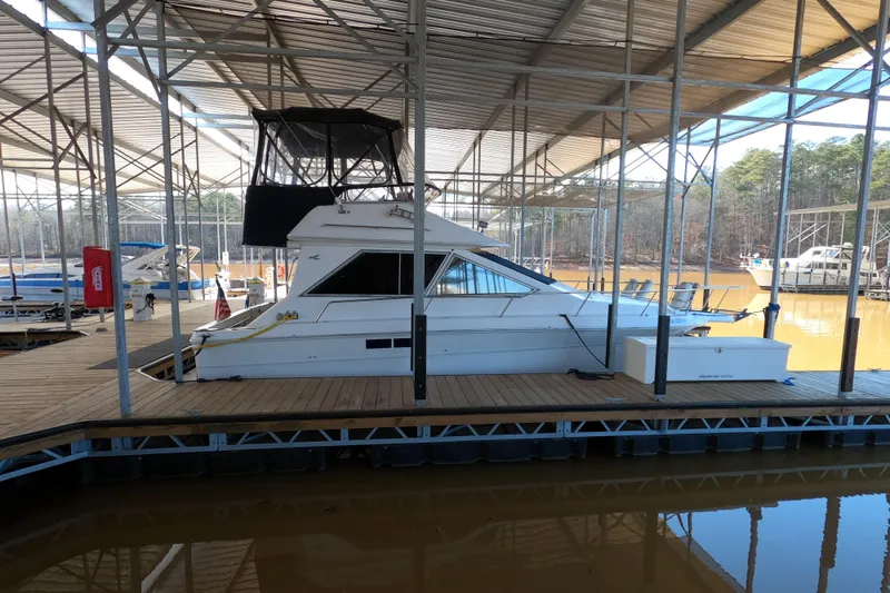 The Image of 1989 Searay 30 Sedan Bridge docked in a covered marina. - 0