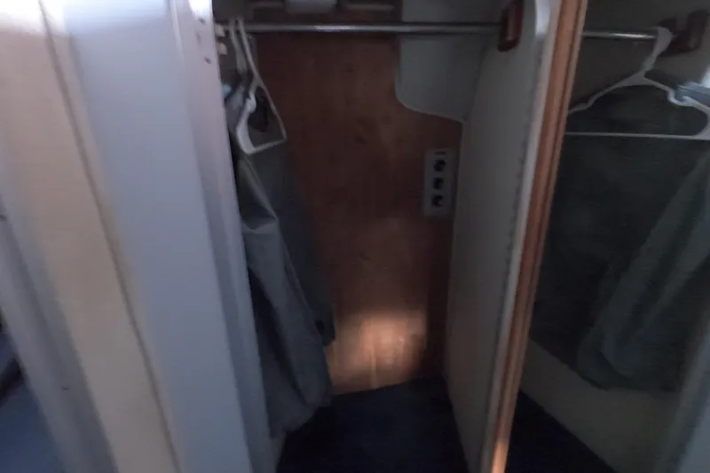Slide: The Image of Interior closet of 1989 Searay 30 Sedan Bridge boat with hangers. - 14