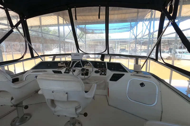 Slide: The Image of 1989 Searay 30 Sedan Bridge helm with dual seats and navigation equipment. - 18