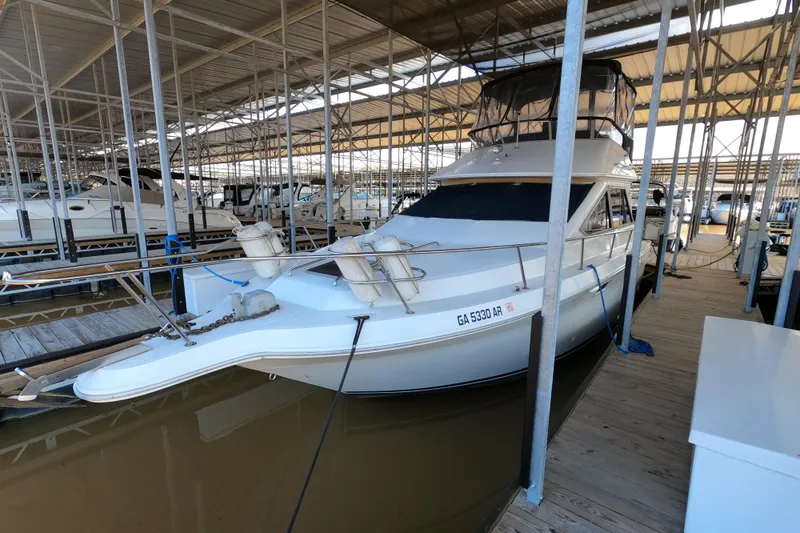Slide: The Image of 1989 Searay 30 Sedan Bridge docked in a covered marina. - 2