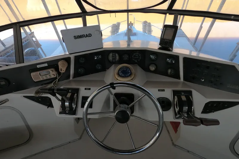 Slide: The Image of 1989 Searay 30 Sedan Bridge helm with steering wheel, controls, and navigation equipment. - 21