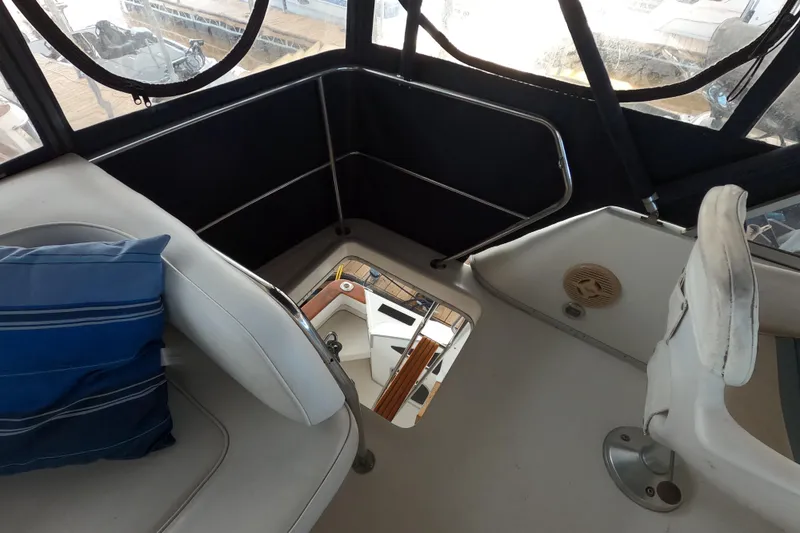 Slide: The Image of 1989 Searay 30 Sedan Bridge interior with seating and hatch, featuring blue cushion. - 22