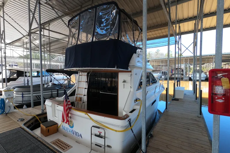 Slide: The Image of 1989 Searay 30 Sedan Bridge docked in a marina, covered and ready for use. - 3