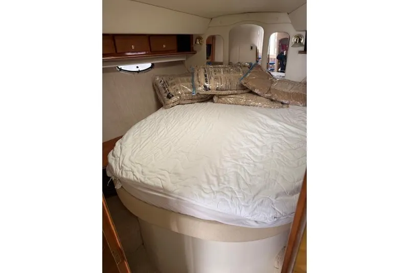 Slide: The Image of 2006 Rinker Fiesta Vee 410 cabin interior with bed and storage cabinets. - 12