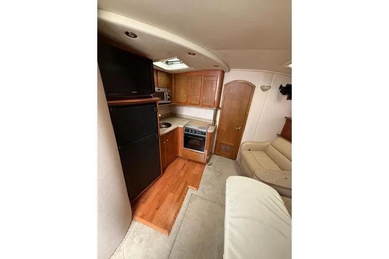 Slide: The Image of 2006 Rinker Fiesta Vee 410 interior with kitchen and seating area. - 13