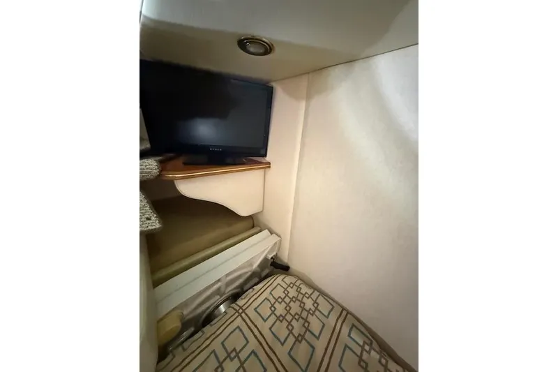 Slide: The Image of 2006 Rinker Fiesta Vee 410 cabin interior with TV and patterned upholstery. - 22