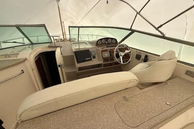 Slide: The Image of 2006 Rinker Fiesta Vee 410 boat interior with helm, steering wheel, and seating. - 23