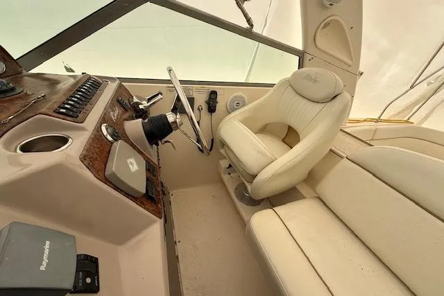 Slide: The Image of 2006 Rinker Fiesta Vee 410 helm with beige seating and control panel. - 26