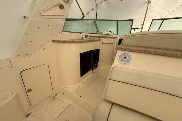 Slide: The Image of 2006 Rinker Fiesta Vee 410 boat interior with seating and kitchenette area. - 28