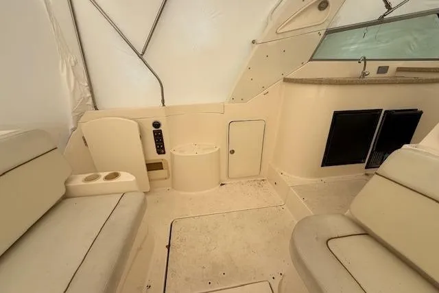 Slide: The Image of 2006 Rinker Fiesta Vee 410 interior with beige seating and storage compartments. - 29