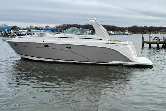 Slide: The Image of 2006 Rinker Fiesta Vee 410 yacht on calm water, side view. - 3