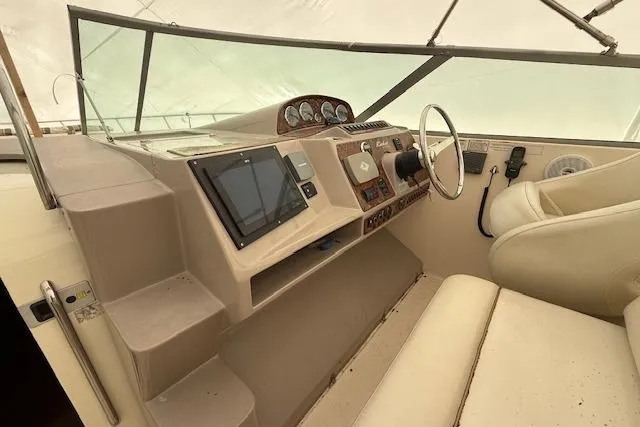 Slide: The Image of 2006 Rinker Fiesta Vee 410 boat cockpit with steering wheel and navigation instruments. - 31