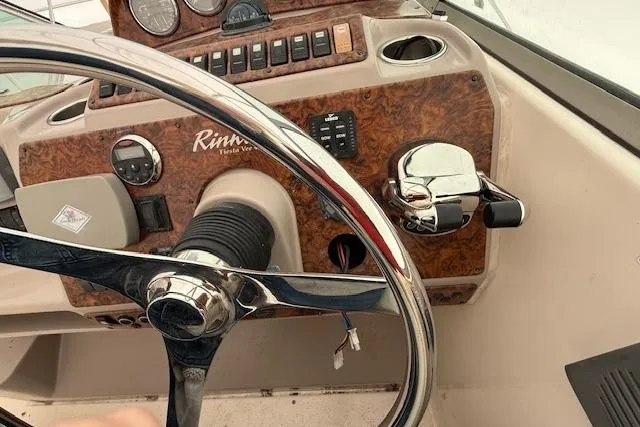 Slide: The Image of Steering wheel and controls of 2006 Rinker Fiesta Vee 410 boat. - 32