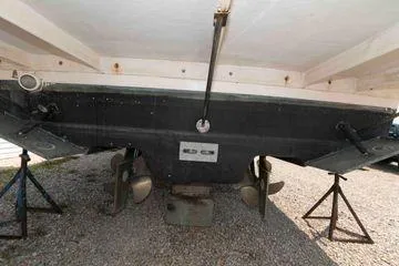 Slide: The Image of 2006 Rinker Fiesta Vee 410 boat hull and propellers on stands. - 38