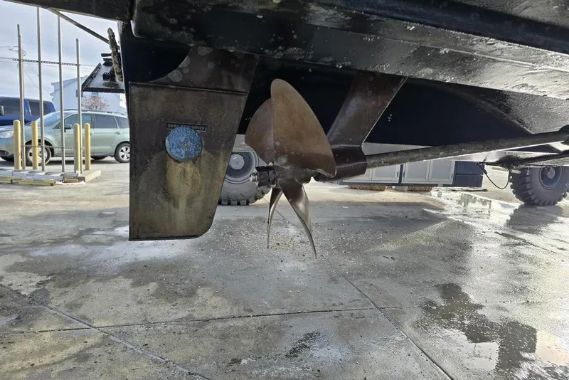 Slide: The Image of 2006 Rinker Fiesta Vee 410 boat propeller and rudder on a concrete surface. - 39