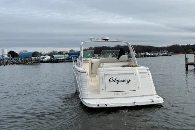 Slide: The Image of 2006 Rinker Fiesta Vee 410 boat named "Odyssey" on water, rear view. - 5
