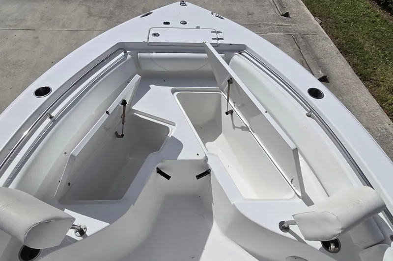 Slide: The Image of 2017 Sea Hunt Ultra 225 boat with open storage compartments on deck. - 12