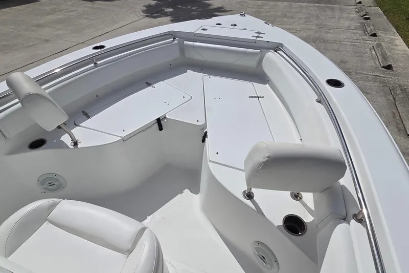 Slide: The Image of 2017 Sea Hunt Ultra 225 boat interior with white seating and storage compartments. - 13