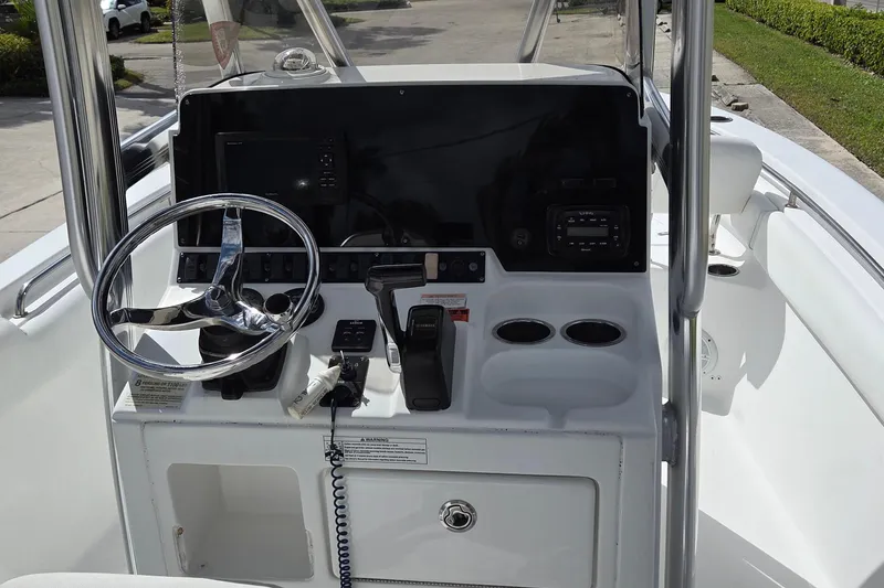 Slide: The Image of 2017 Sea Hunt Ultra 225 boat console with steering wheel and controls. - 16