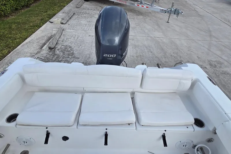 Slide: The Image of 2017 Sea Hunt Ultra 225 boat with white seating and 200 HP outboard motor. - 5