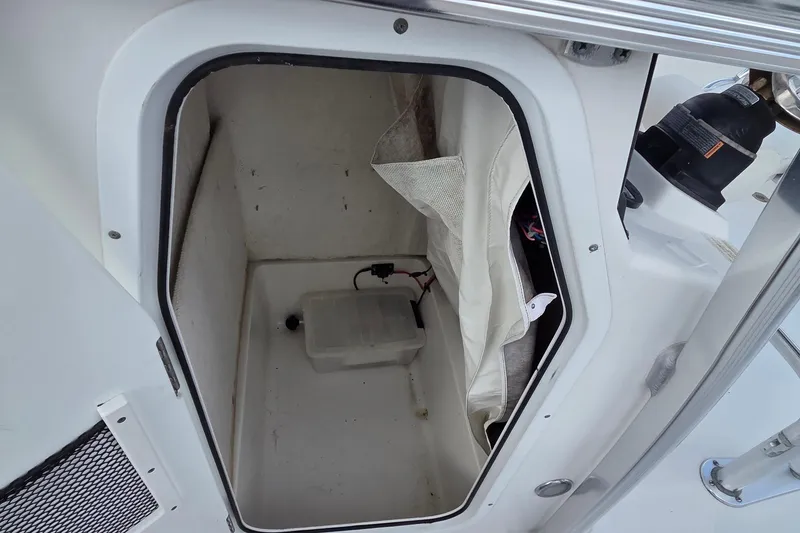 Slide: The Image of Storage compartment inside a 2017 Sea Hunt Ultra 225 boat, featuring a white interior. - 6