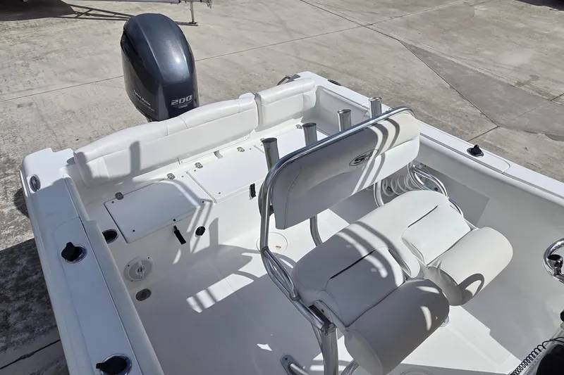 Slide: The Image of 2017 Sea Hunt Ultra 225 boat interior with seating and outboard motor. - 9