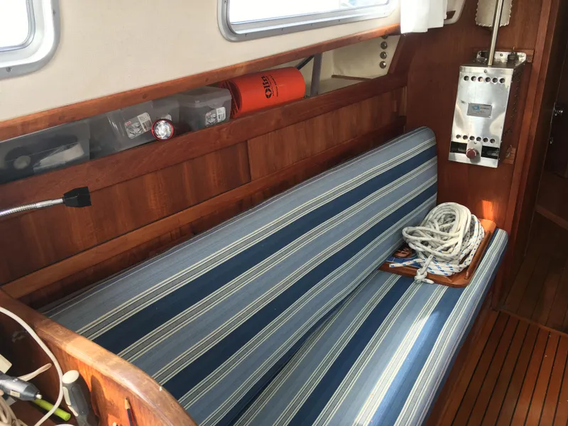 Slide: The Image of Interior of a 1980 Sabre 34 MK II yacht with blue-striped seating. - 11