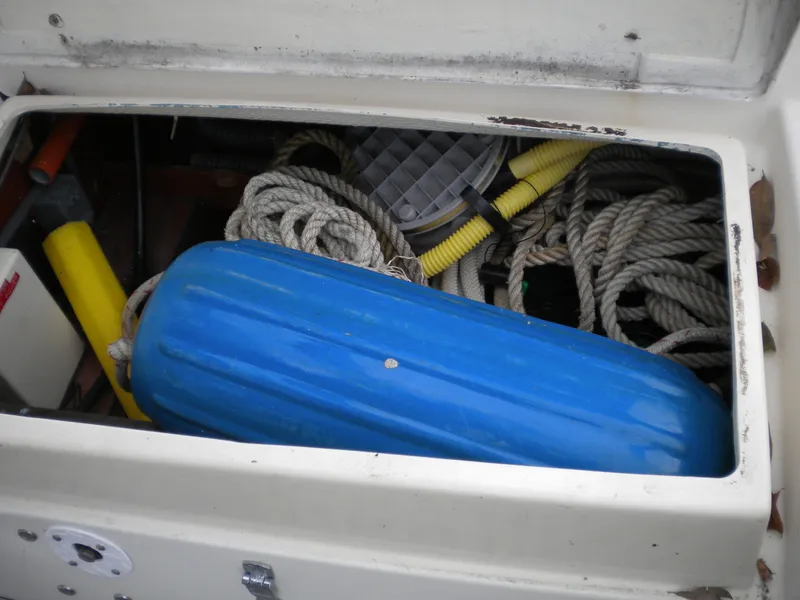 Slide: The Image of Storage compartment of Sabre 34 MK II boat with ropes and fender. - 26