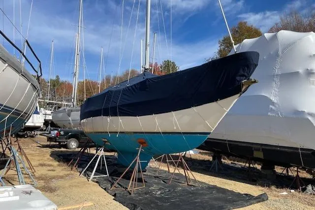 Slide: The Image of 1980 Sabre 34 MK II sailboat on stands, covered, in a boatyard. - 53