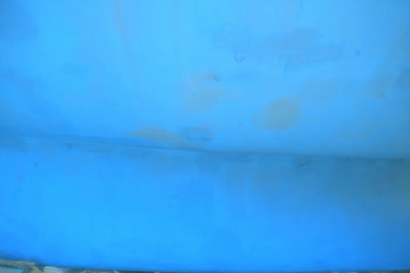 Slide: The Image of Close-up of a blue hull from a 1980 Sabre 34 sailboat. - 56