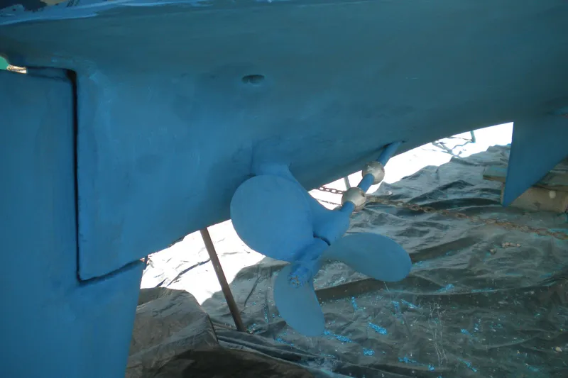 Slide: The Image of Blue-painted propeller of a 1980 Sabre 34 sailboat, displayed on a tarp. - 57
