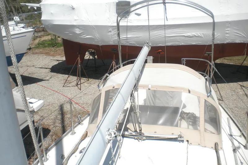Slide: The Image of 1980 Sabre 34 sailboat on land, mast down, covered for storage. - 58