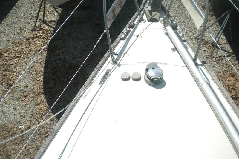 Slide: The Image of Bow of a 1980 Sabre 34 sailboat with deck fittings and railing. - 59