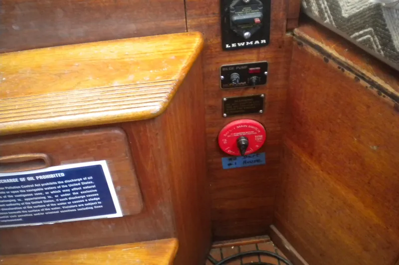 Slide: The Image of Interior controls of a 1980 Sabre 34 sailboat, featuring bilge pump and main switch. - 60