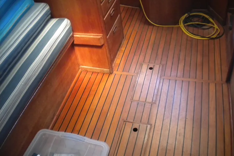 Slide: The Image of Interior of 1980 Sabre 34 sailboat with wooden flooring and striped seating. - 62