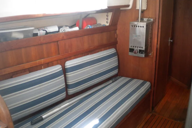 Slide: The Image of Interior of 1980 Sabre 34 sailboat with striped cushions and wooden paneling. - 63