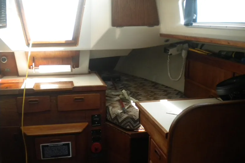 Slide: The Image of Interior of a 1980 Sabre 34 sailboat featuring wooden cabinetry and a cozy sleeping area. - 65